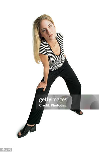 woman wearing black sandals and black pants and a strip shirt and necklace leans forward on her knee as she stares at the camera - president trump hosts public safety medal of valor awards at white house stockfoto's en -beelden