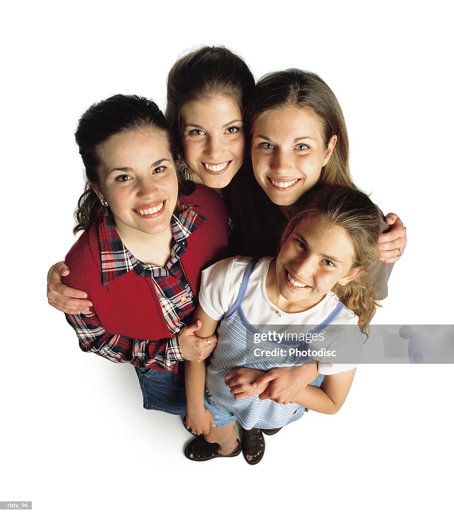 Four teenage girls casually dressed gather together as they look up toward the camera