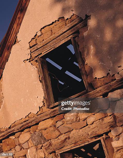an old wooden and stone building with its window showing a ceiling that_s falling apart - thats stock pictures, royalty-free photos & images