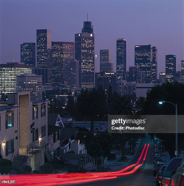 a blur of brake lights going down a road on a hill leading to los angeles with cars and buildings lining the road - awareness film festival opening night premiere of the road to yulin and beyond arrivals stockfoto's en -beelden