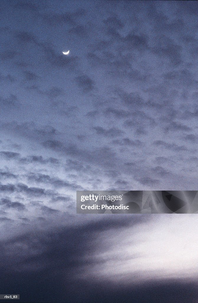 White abstract clouds cover a white crescent moon