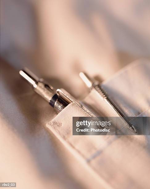 two pens stick out of a white pocket from a lab coat or shirt - white shirt ストックフォトと画像