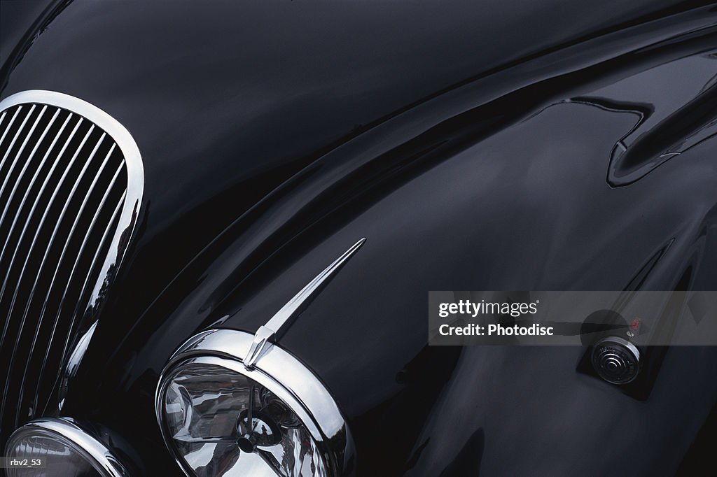 A black jaguar sports car hood showing a grill and headlight