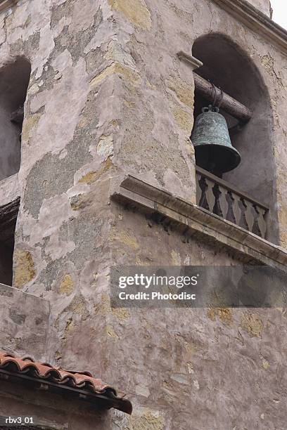 an old stone stucco mexican mission style bell tower inside an arch - bell stock-fotos und bilder