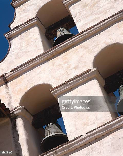 white stucco walls house bells in mexican mission style buildings below a blue sky - president obama speaks in the east room of white house on efforts to reduce gun violence stockfoto's en -beelden