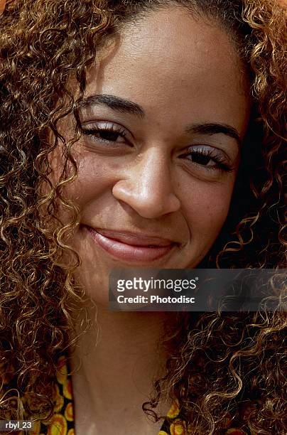 a head shot of a young african-american woman with long dark curly hair - curly stock pictures, royalty-free photos & images