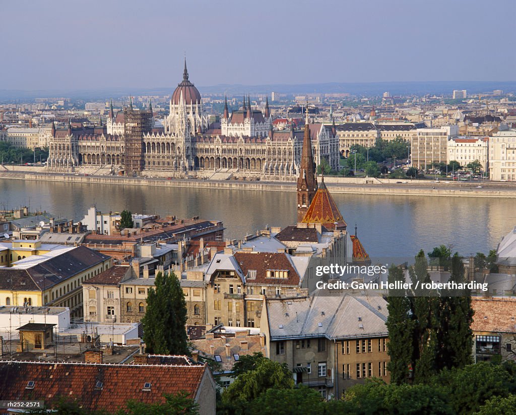 Houses and church in Buda with the River Danube beyond and the Parliament Building in Pest in Budapest, Hungary