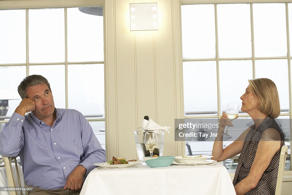 Mature couple sitting at table in restaurant