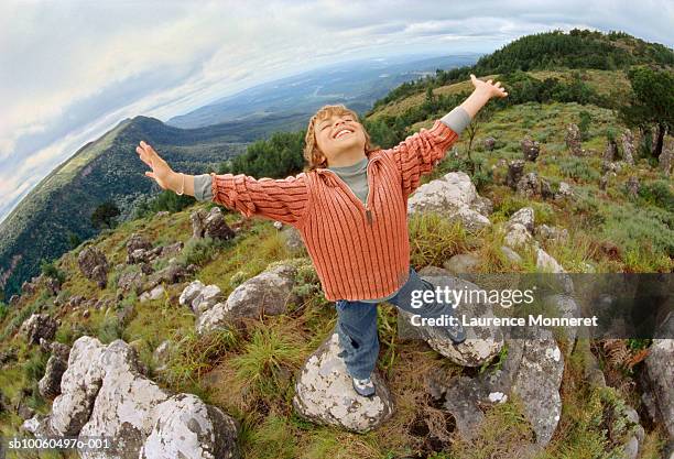 boy (8-9) standing on mountain top, elevated view (fish-eye lens) - fisheye stock pictures, royalty-free photos & images
