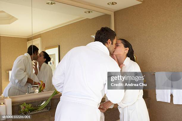 couple wearing bathrobes kissing in bathroom - couple and kiss and bathroom 個照片及圖片檔