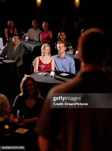 couple in audience watching comedian, smiling - stand up comedy ストックフォトと画像