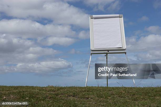 presentation board in field against cloudy sky - flipchart stock pictures, royalty-free photos & images