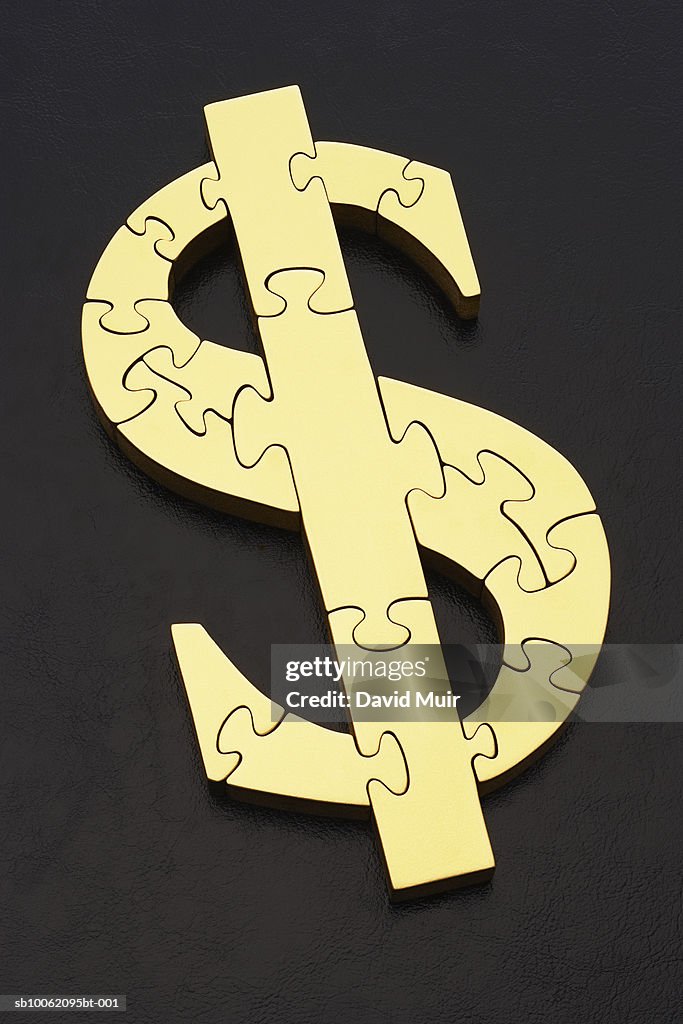 Jigsaw puzzle in shape of dollar sign