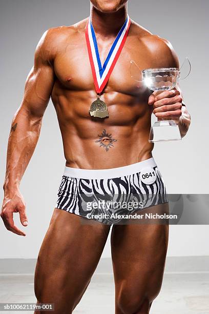 male body builder holding trophy, mid section - bodybuilder posing stock pictures, royalty-free photos & images
