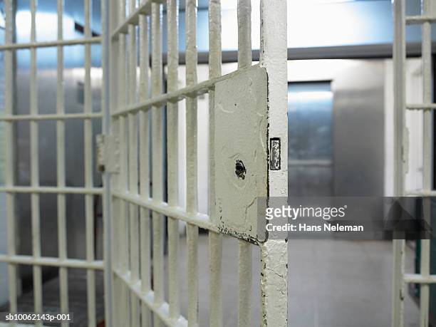 open door to prison cell - prison imagens e fotografias de stock