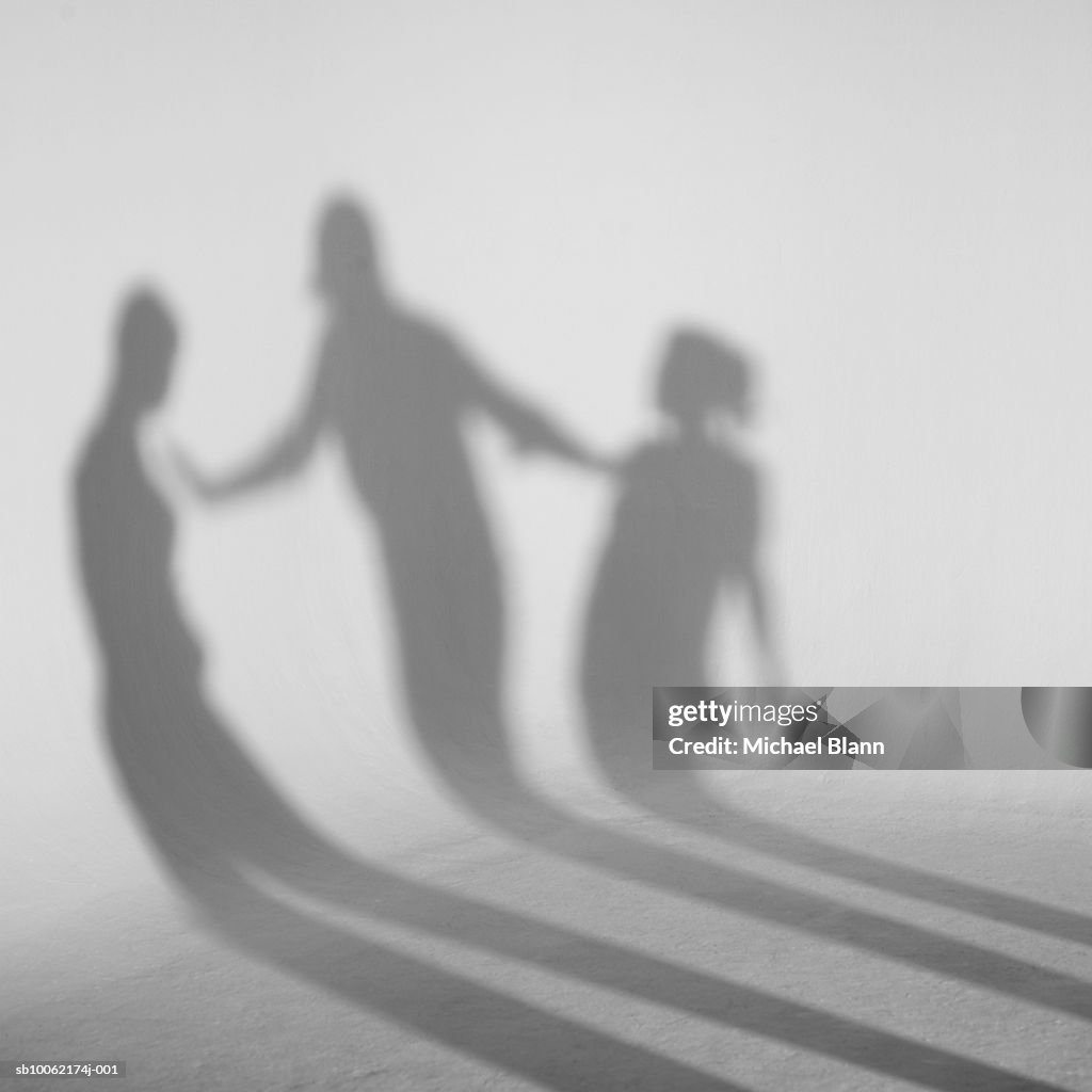 Shadows standing in front of white background