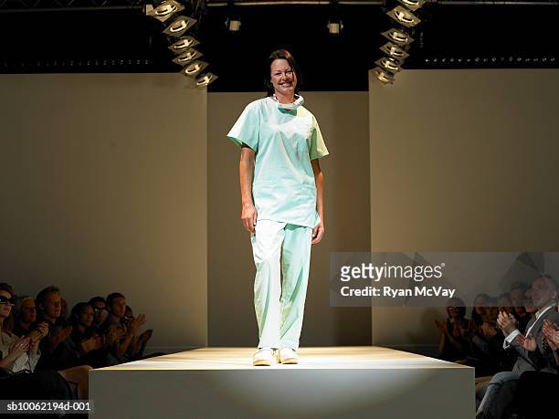 female nurse on catwalk, portrait - fashion show stockfoto's en -beelden