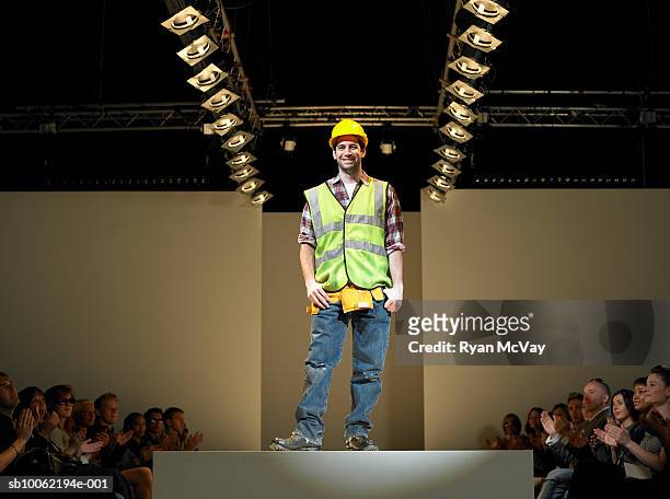 spectators applauding construction worker on catwalk - fashion show 個照片及圖片檔