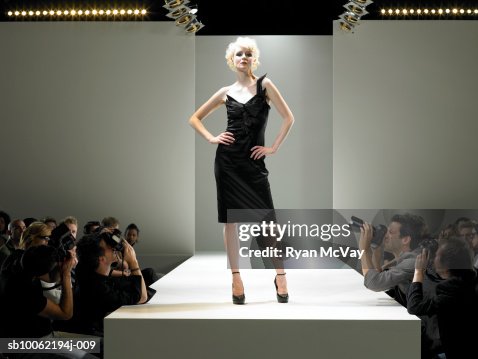 Paparazzi photographing fashion model on catwalk Paparazzi photographing fashion model on catwalk