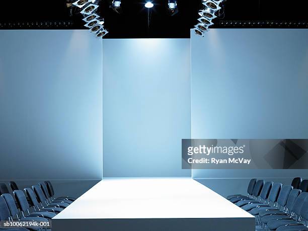 empty catwalk and seating for fashion show - fashion show stockfoto's en -beelden