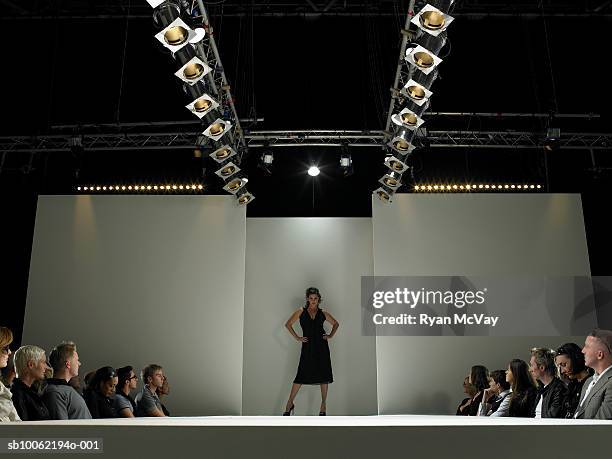 spectators watching fashion model on catwalk - stage light stock pictures, royalty-free photos & images