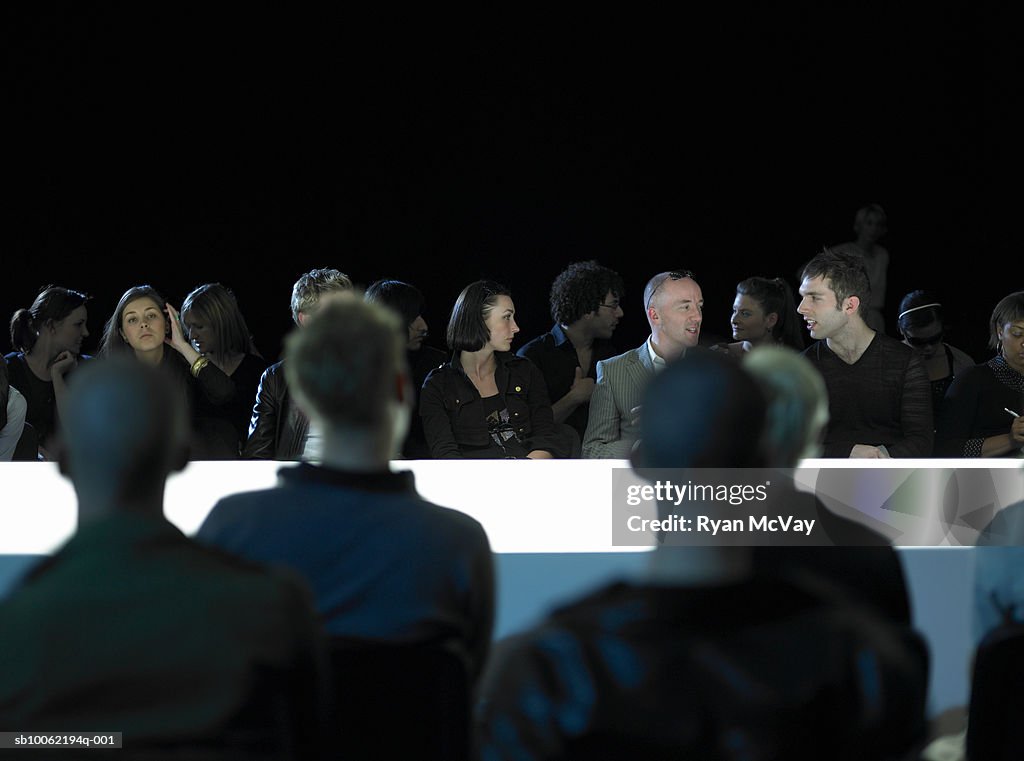 Spectators sitting by catwalk at fashion show