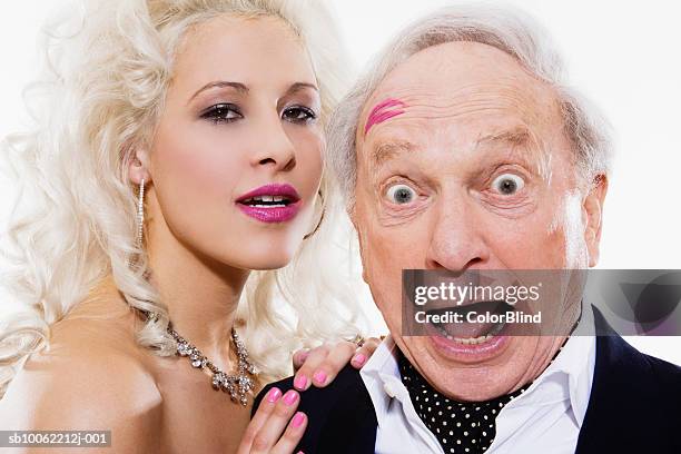 young woman and senior man with lipstick mark on forehead, portrait - sugar daddies stock pictures, royalty-free photos & images