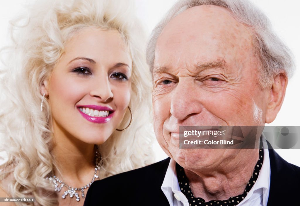 Young woman and senior man smiling, portrait, close-up