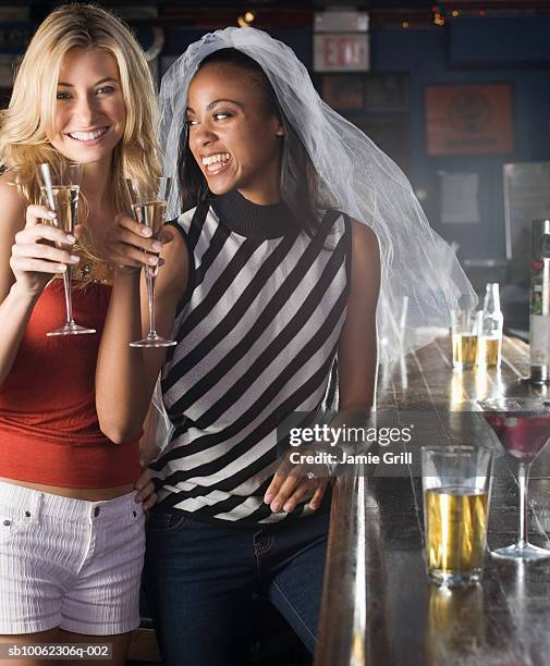 two young woman holding champagne flute, smiling - despedida de solteiro - fotografias e filmes do acervo