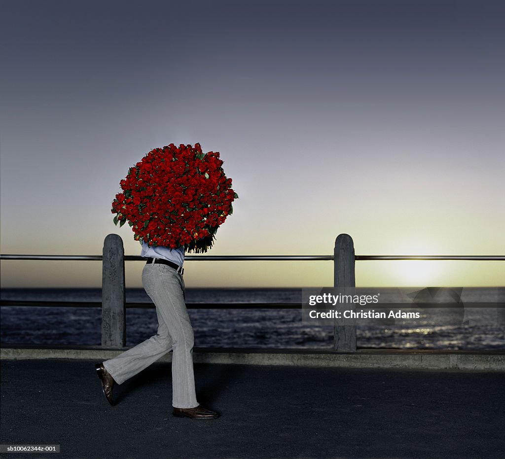 Man carrying bouquet of roses