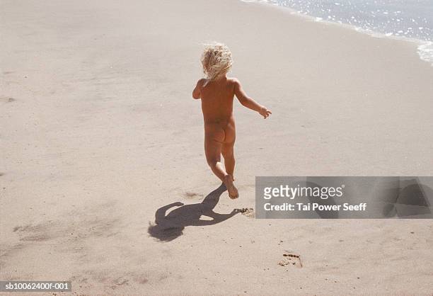girl running on beach, rear view - no clothes girls stock pictures, royalty-free photos & images