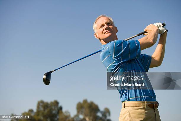 mature man golfing - golf short iron stock pictures, royalty-free photos & images