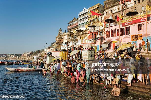 india, varanasi, ganges river, pilgrims on ghats - varanasi ganges stock pictures, royalty-free photos & images