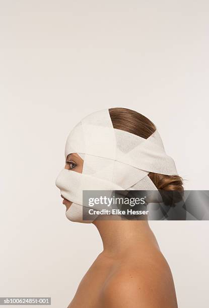 young woman with bandaged face, profile - bandage stock pictures, royalty-free photos & images