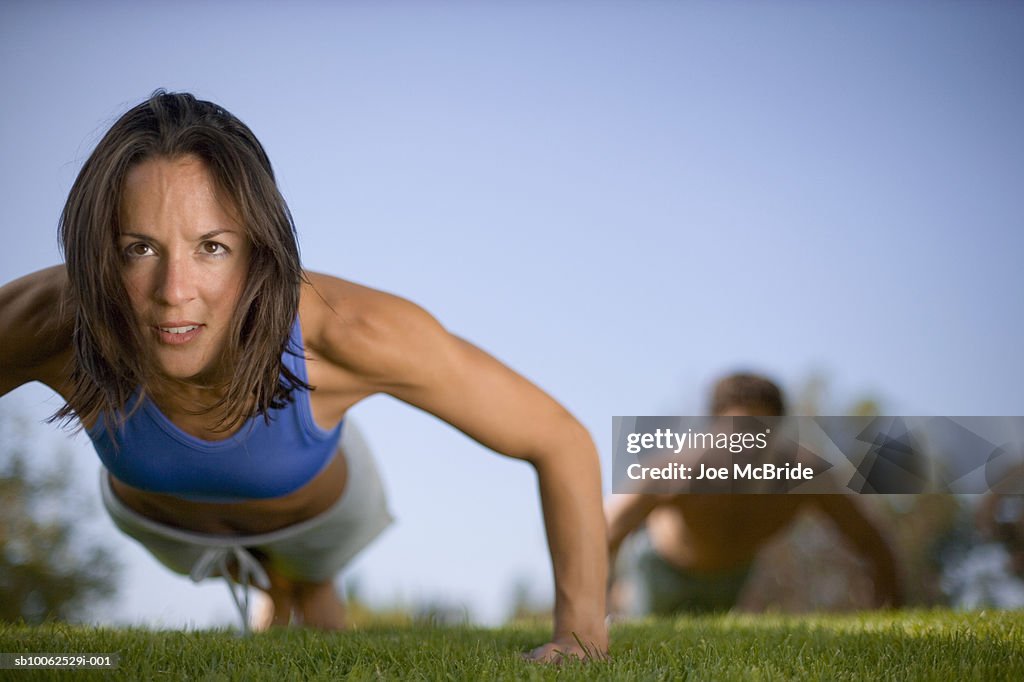 Woman performing push up in park