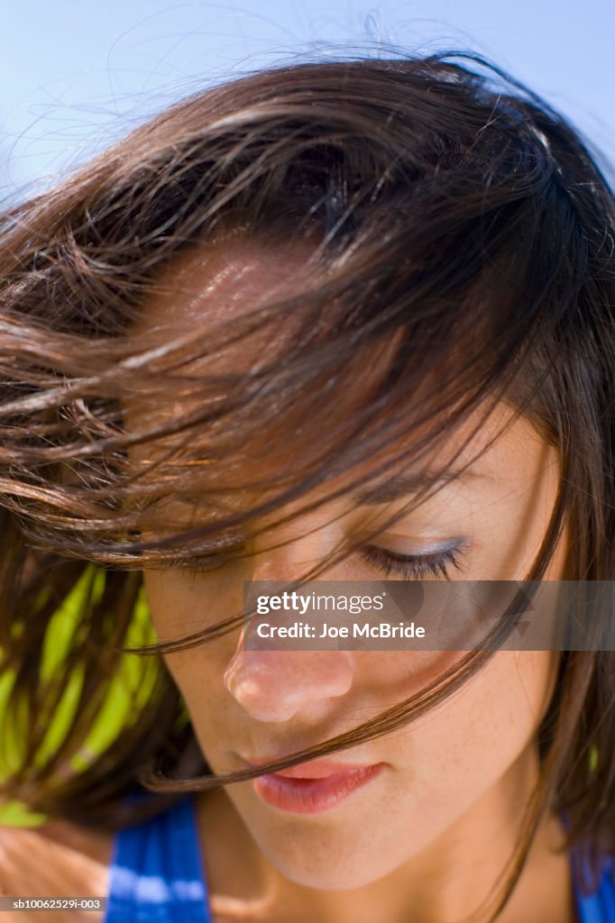 Windswept woman outdoors, close-up