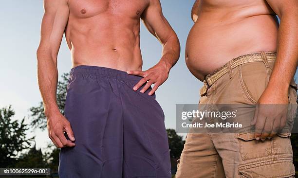 torsos of fit man and overweight man, outdoors - fat guy belly stock pictures, royalty-free photos & images