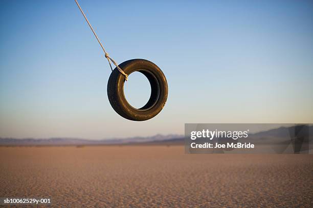 tire swing in desert - tyre swing stock pictures, royalty-free photos & images