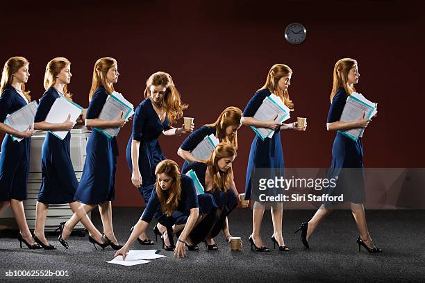 businesswoman walking in office holding file (multiple exposure) - repetition stock pictures, royalty-free photos & images