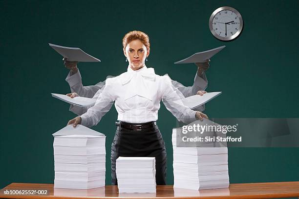 businesswoman holding sheets of paper, portrait - clock person desk stock-fotos und bilder