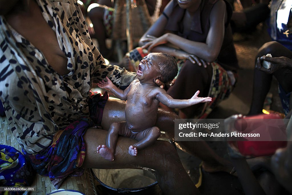 Teenage girl (16-17) with new born baby, elevated view