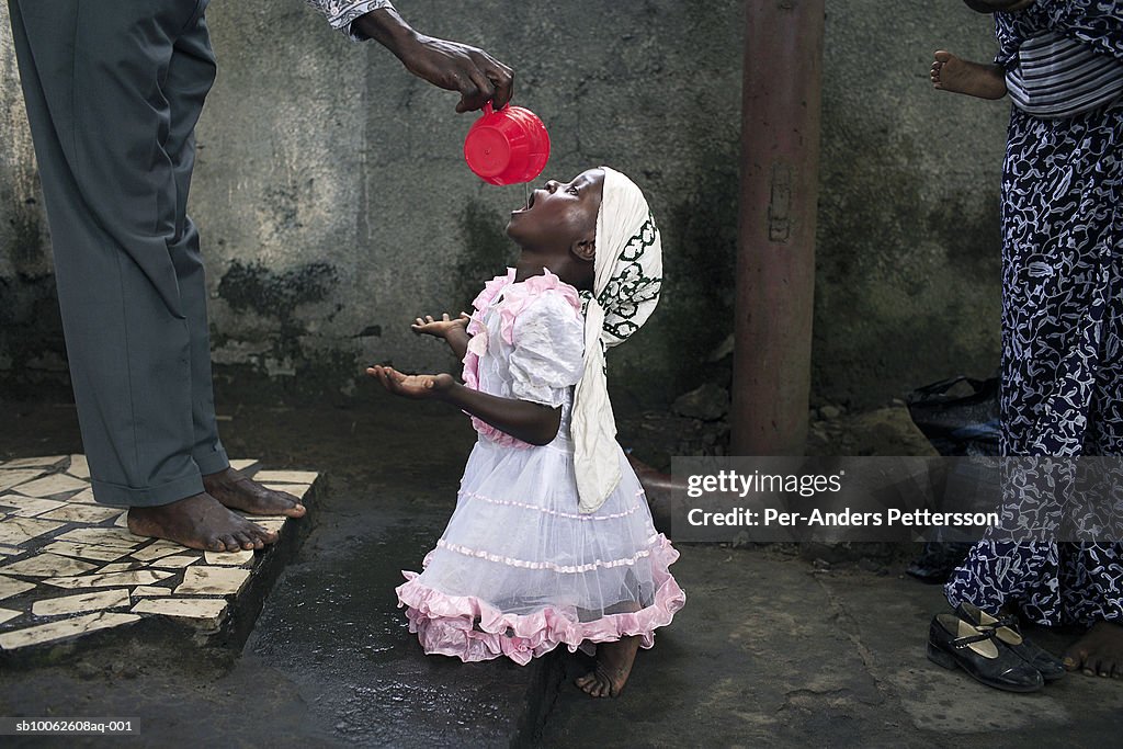 Girl drinking holy water