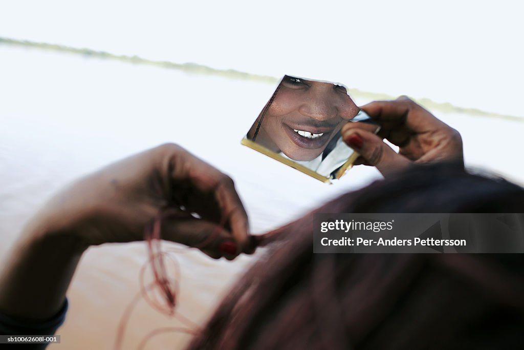 Woman looking hairstyle in mirror