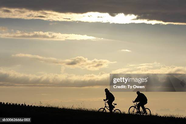 two people ride bycycles - wt1 stock pictures, royalty-free photos & images