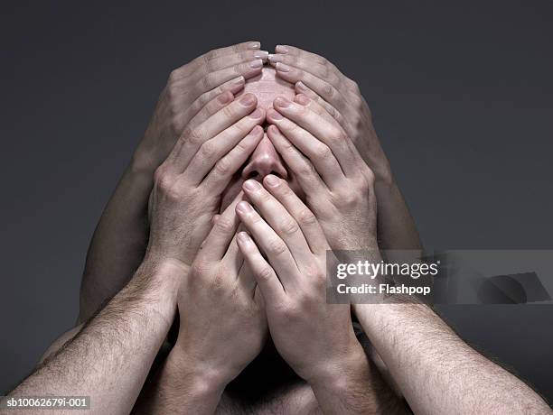 young men and woman covering face, close-up - see no evil stock pictures, royalty-free photos & images