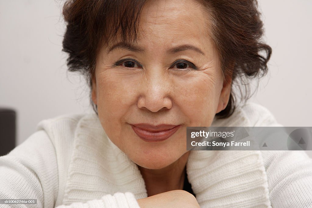 Portrait of senior woman in sweater, smiling, close-up