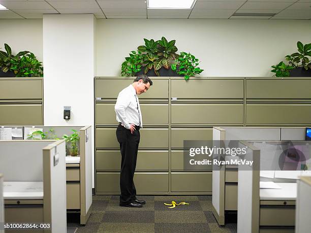 businessman stares at banana peel in corridor - careless stock pictures, royalty-free photos & images