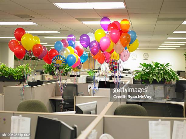 groups of balloons surround cubicle - balloon knot stock pictures, royalty-free photos & images