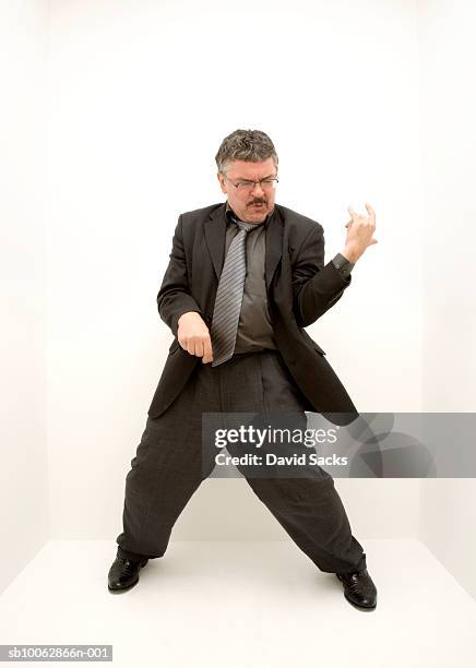 mature man playing air guitar, high angle view - cantante rock foto e immagini stock