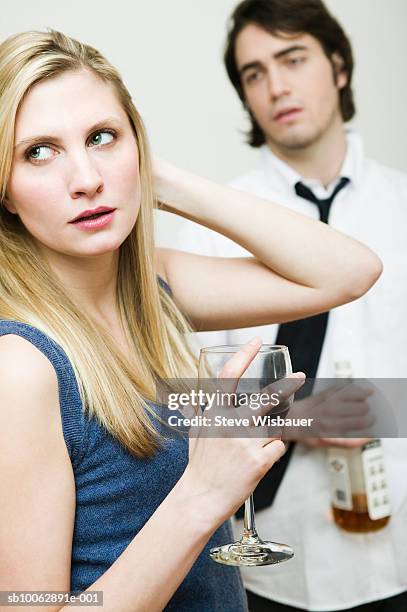 young couple with alcoholic beverages, indoors - embarrassed girlfriend stock pictures, royalty-free photos & images